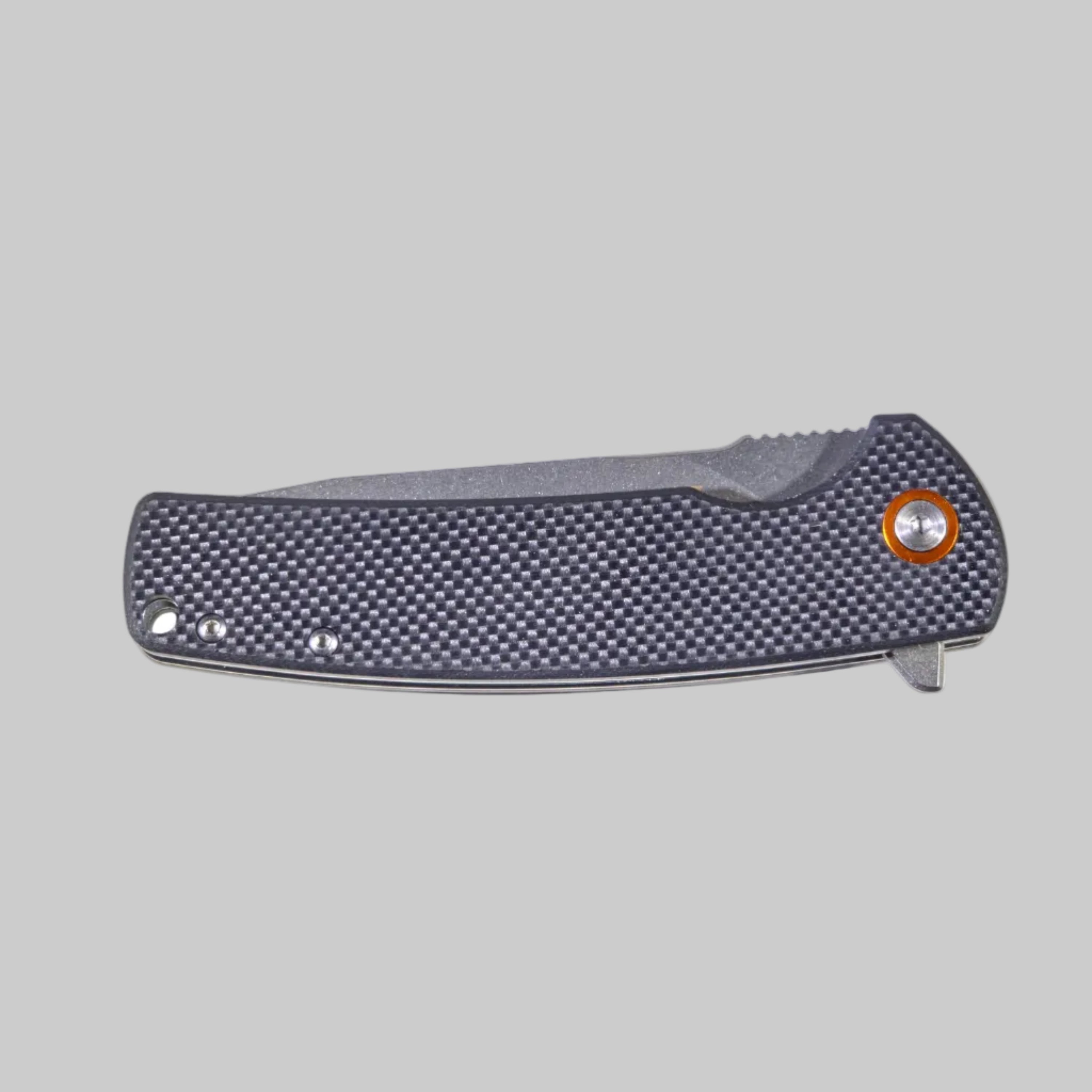 Folding knife with textured handle on a light gray background