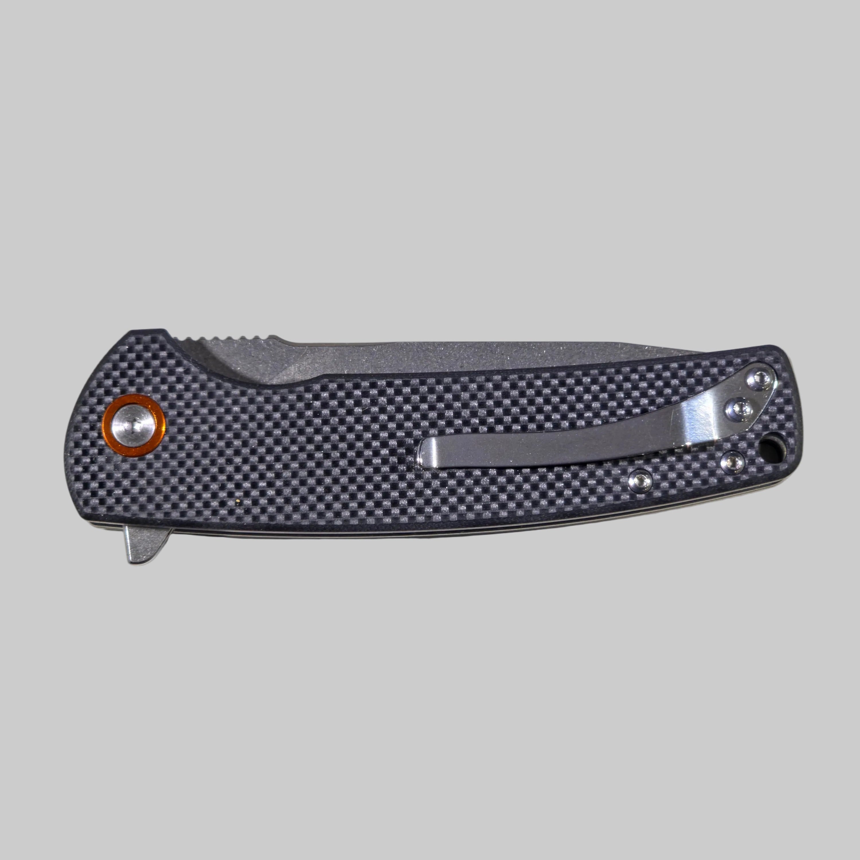 Folding knife with carbon fiber handle on a white background