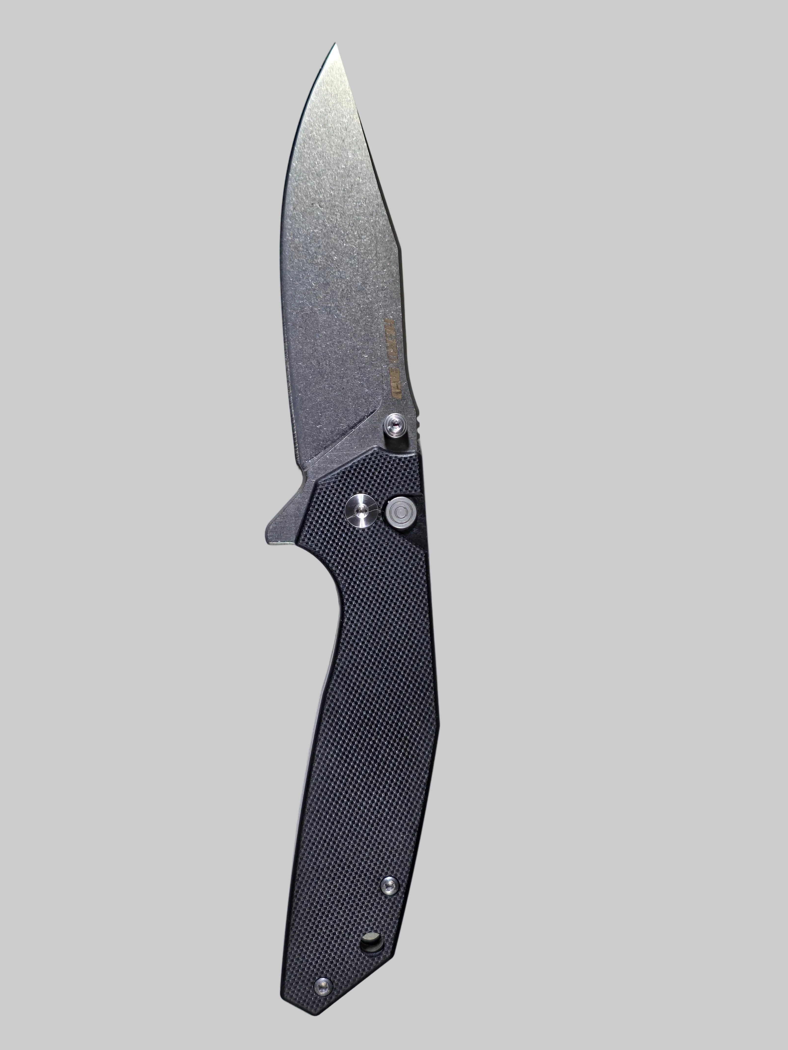 Folding knife with a black handle on a light gray background